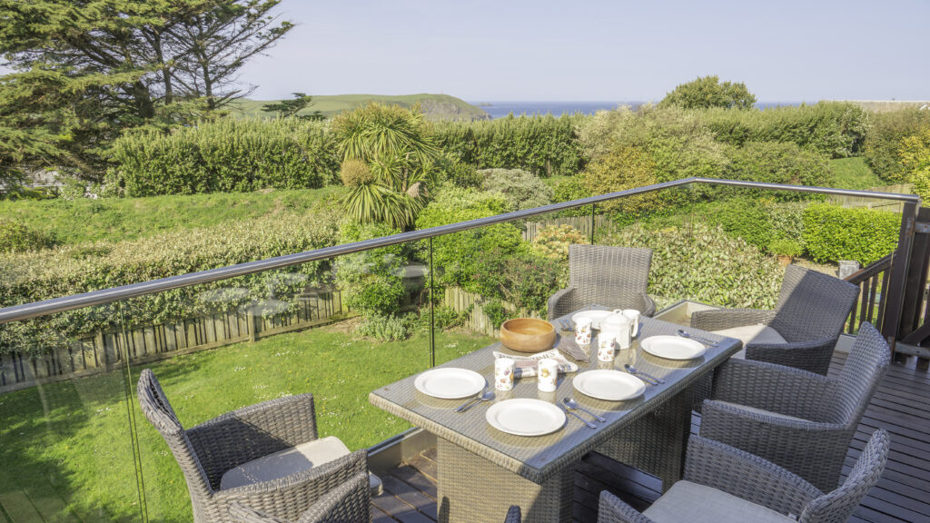 Villa 33 balcony overlooking the garden. Dining table and chairs.